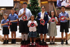 Kids holding Jesse Tree symbols